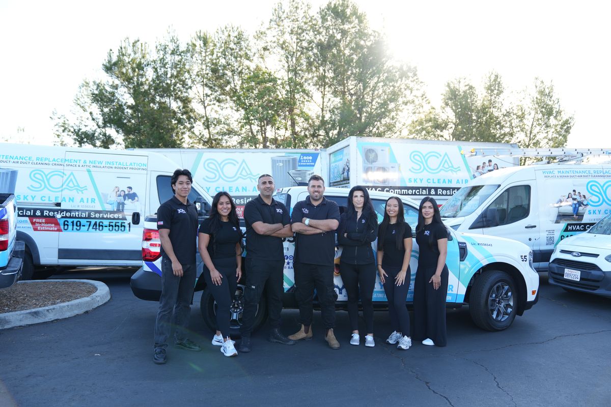 The Sky Clean Air team in front of their service vans